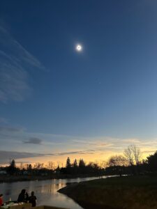 The moon totally eclipses the Sun above Chiefswood Park.